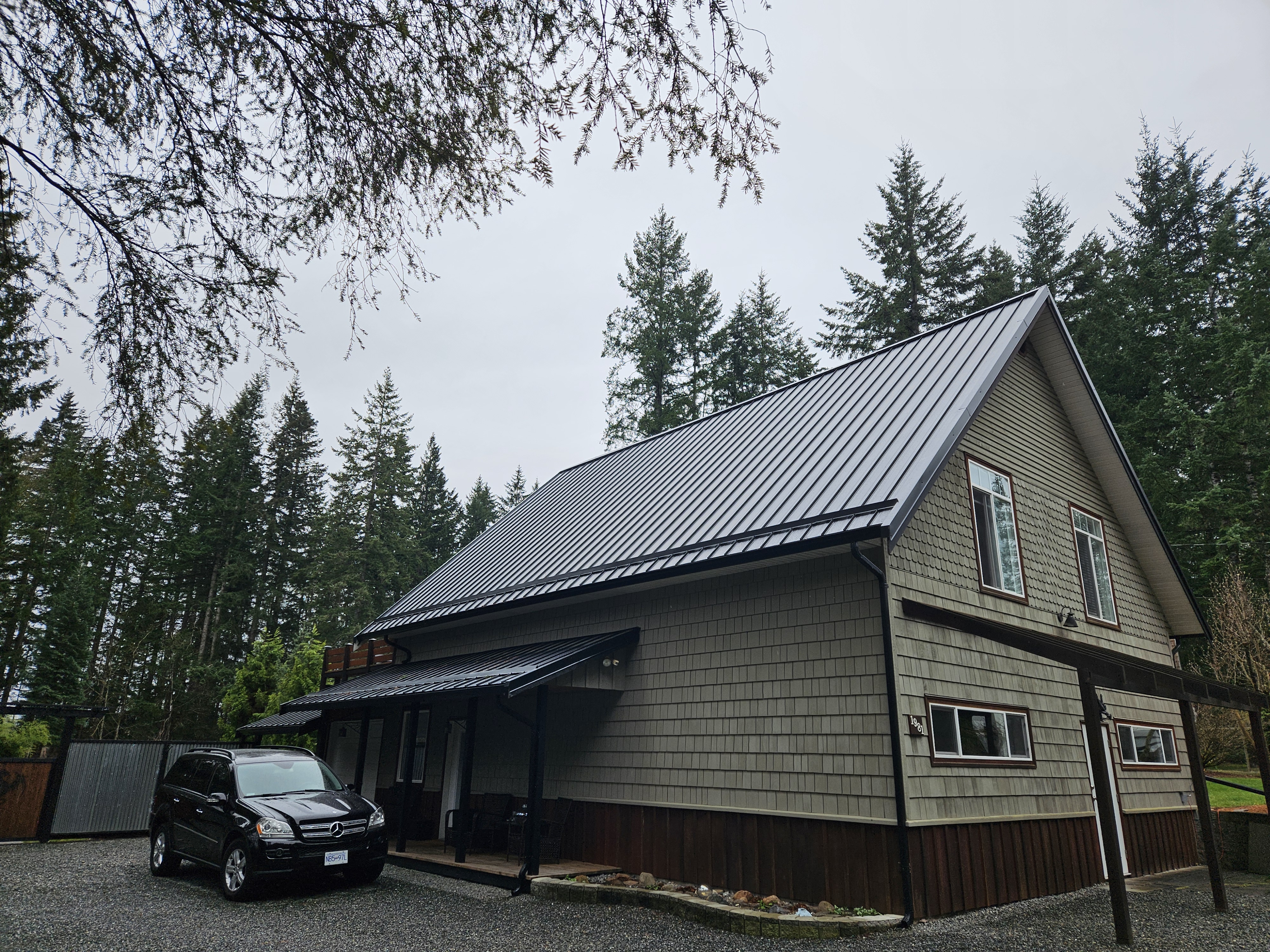 Completed roof on a forested Black Creek property